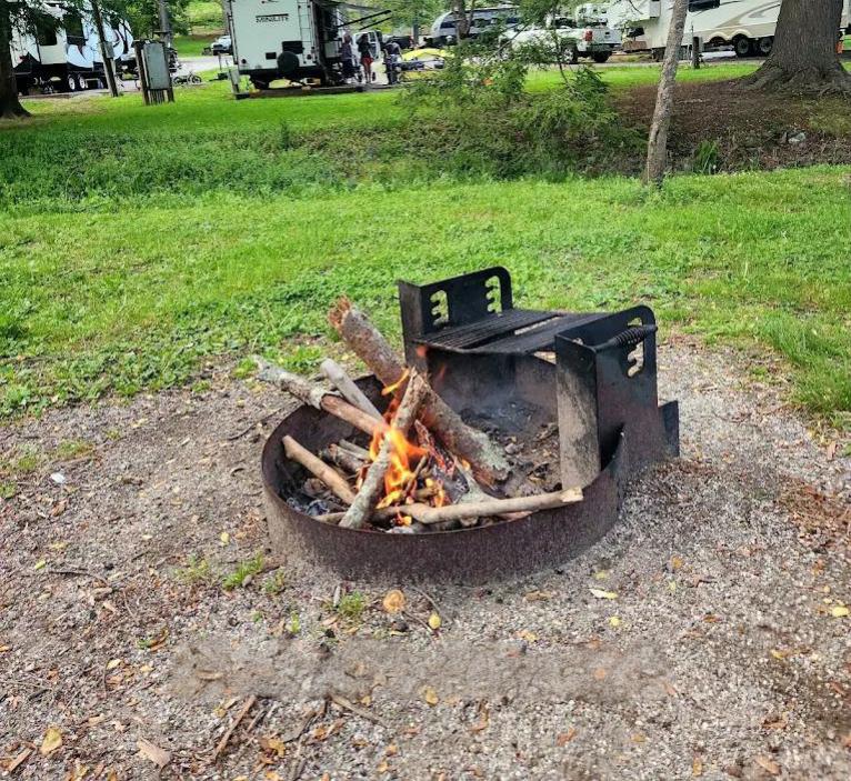 Small campfire contained inside a campground fire ring