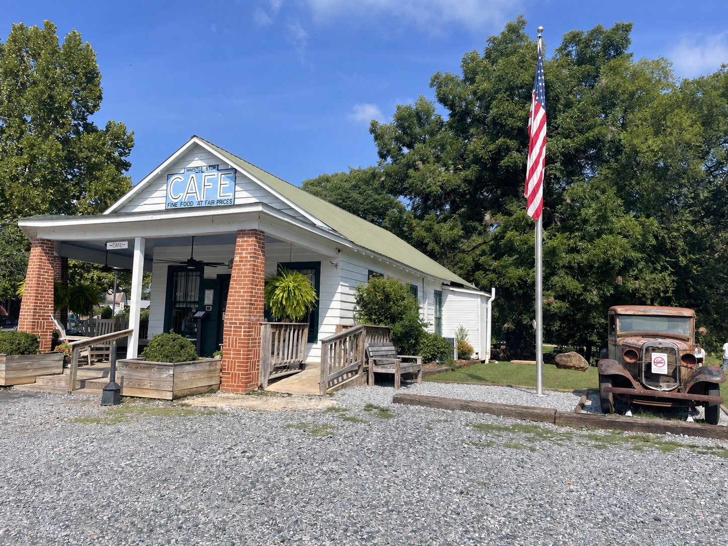 The Whistle Stop Café in Juliette, with its porch, American flag and antique truck
