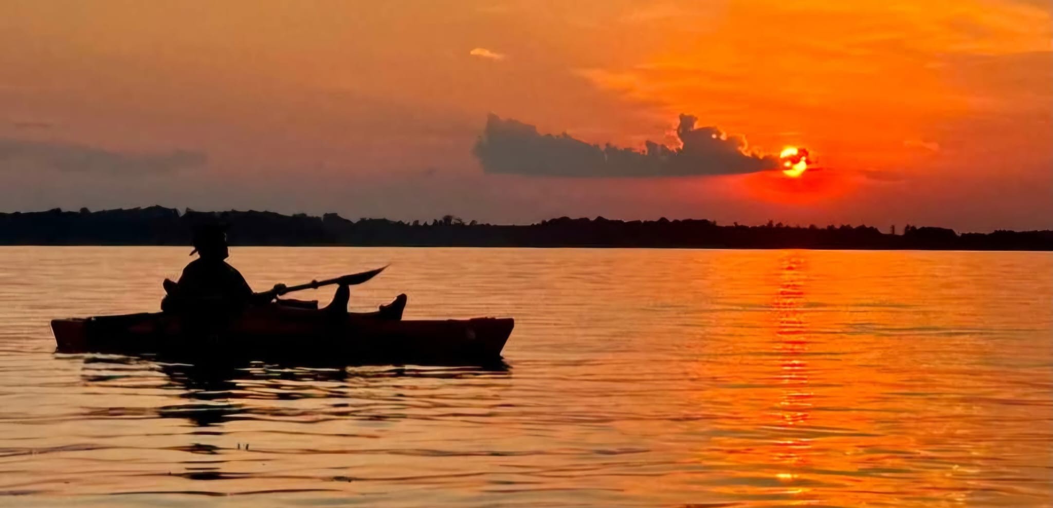 Lee Ratliff kayaking on Lake Juliette at sunset