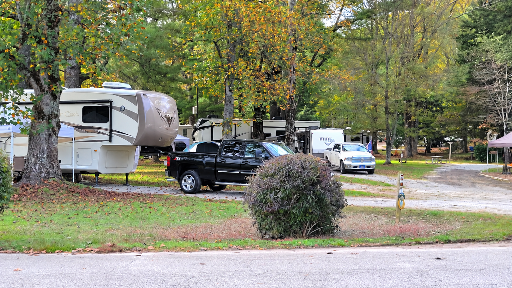 RV parked at a wooded campground campsite